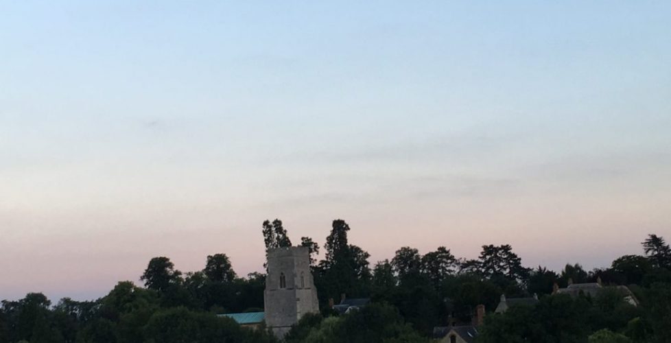 Dusk and the moon over a village