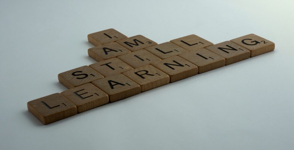 Image of letter tiles spelling "I am still learning"