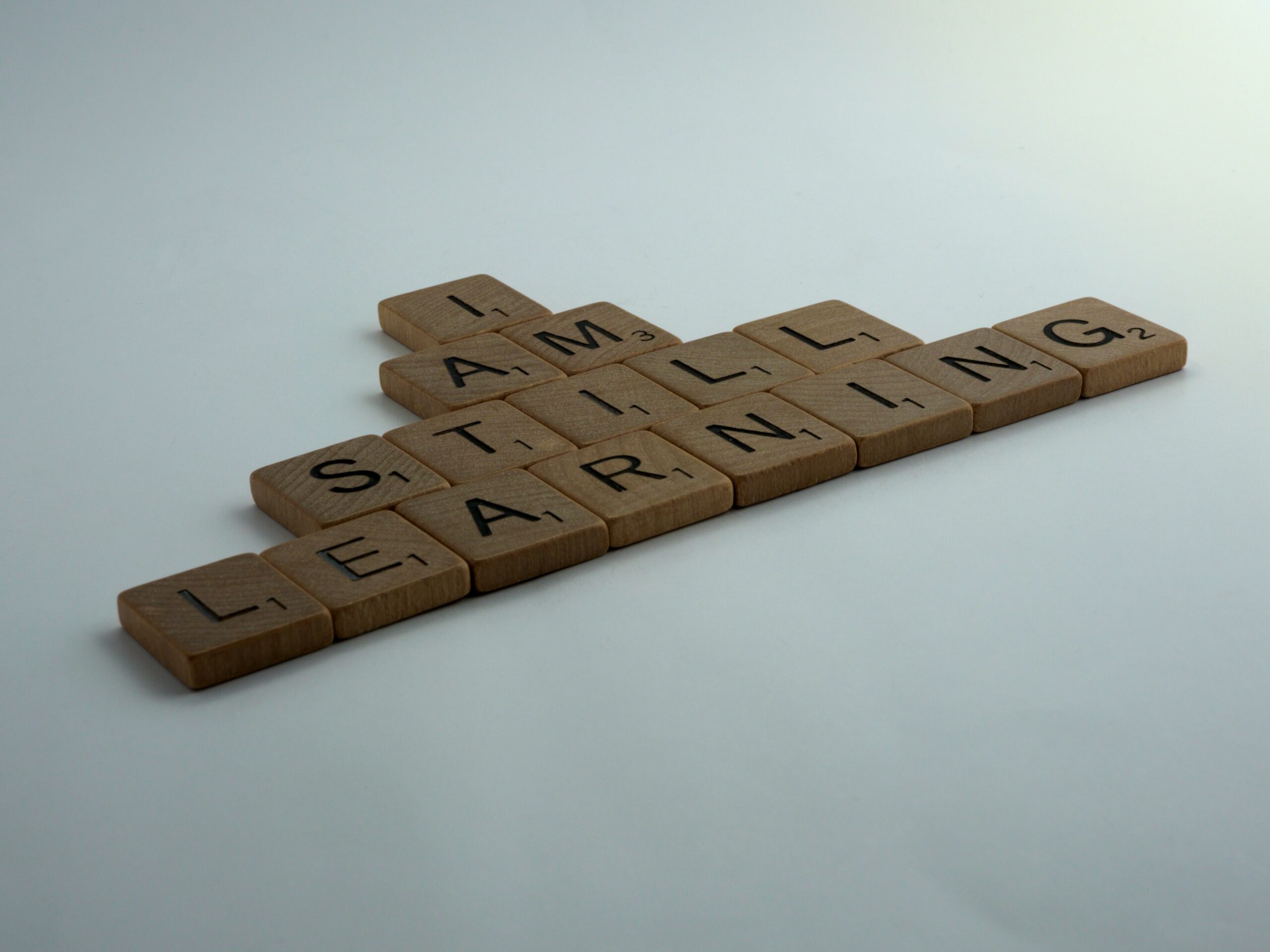 Image of letter tiles spelling "I am still learning"